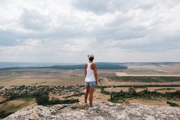 Fototapeta premium Young woman hiker in mountains. Travel, vacation, trekking, hiking concept
