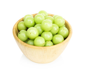 Fresh indian gooseberry in wooded bowl isolated on white background, herb and medical fruit for health care concept