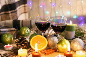 Two glasses of wine in the New Year decorations. Christmas background. New Year's lights