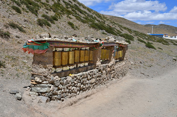 Naklejka premium China, Tibet. Old ritual Buddhist drums on the trail along the way of Cora from Dorchen town around mount Kailas