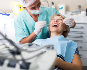 Male dentist treating female patient