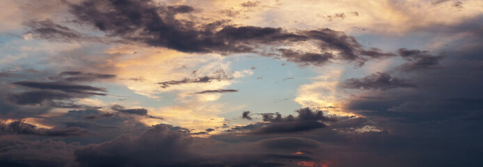 panoramic view of colorful sky with dramatic clouds in the evening mood