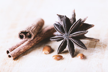Star anise with cinnamon sticks on old wooden background close-up with copyspace.