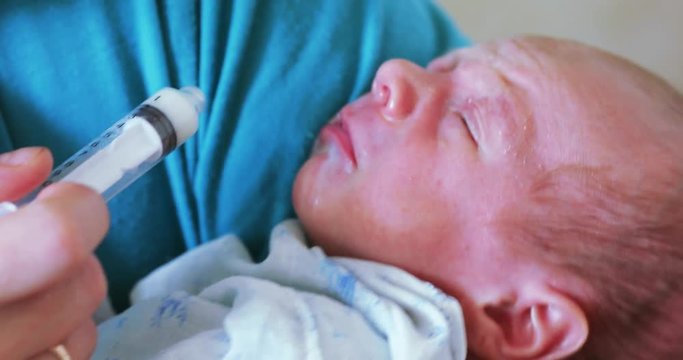 Artificial feeding of the child with a syringe
