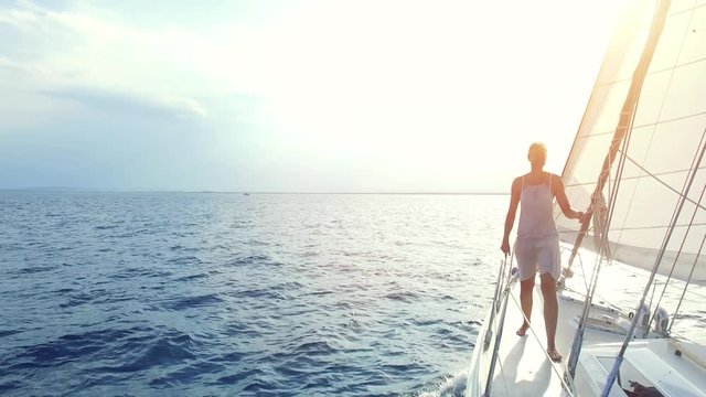 Woman on sail boat walks back to booth during excursion. 4k Video.