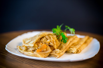 boiled sweet pumpkin porridge with raisins and nuts in a glass bowl
