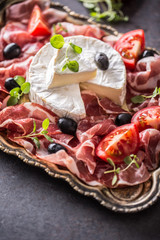 Cheese camambert from prosciutto tomatoes olives and oregano.