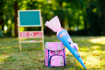 School beginning concept. Satchel and schoolbag, backpack, desk and traditional German school cone...