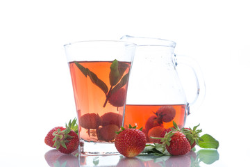 Sweet compote of ripe red strawberries in a glass decanter