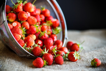 ripe red strawberry on a table with burlap