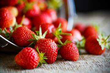 ripe red strawberry on a table with burlap