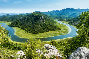 The horseshoe bend of the Rijeka Crnojevica River in Montenegro. This view is one of the most spectacular views in Montenegro and taken just before the river enters the Skada Lake - obrazy, fototapety, plakaty