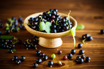 ripe berries black currants on a wooden table