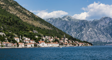 Fototapeta na wymiar The bell tower of St Nicholas Church and the village of Perast in Montenegro. Perast is a beautiful village that sits on the bay of Kotor on the adriatic sea.