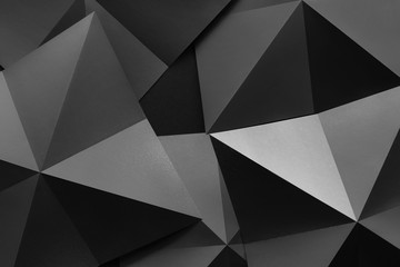 Close-up of pyramidal black shapes, abstract background
