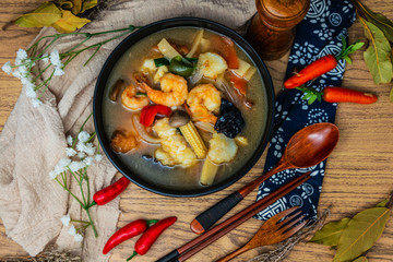Bowls of Asian soup noodles and vegetables with Chopstick