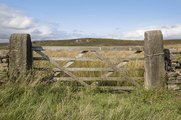 A five bar wooden gate and gate posts in the Peak District