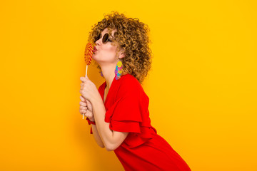 Attractive woman with short curly hair with candy