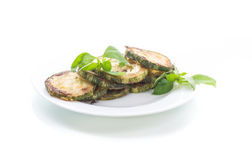 Fried zucchini in a white plate isolated