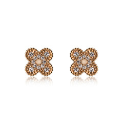 Pair of golden diamond earrings isolated on white