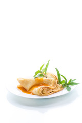 sweet thin pancakes with jam in a plate