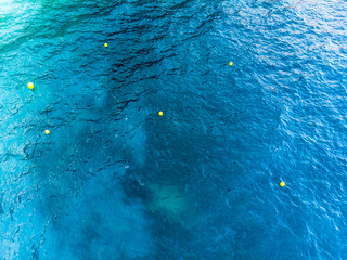 Six buoy and sea marker in clear, azure, deep green and dark blue Mediterranean sea. Seacolor...