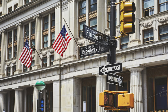 Sign post and traffic lights in downtown