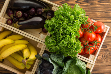 Assorted fresh organic vegetables in wooden boxes