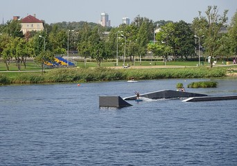 Wake-boarding Center Park With Springboard For Surfing Jumping. Water Sport Recreation and Entertainment Center on Daugava River in Riga City.   