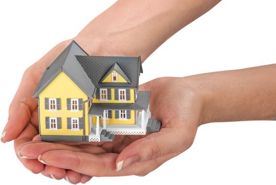 hand holding a miniature house model