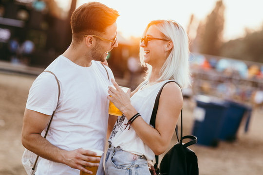 Young couple at the music festival having fun 