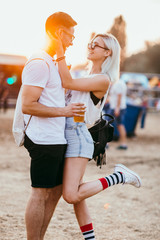 Young couple at the music festival having fun 
