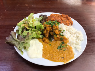 Homemade chicken tikka, indian cuisine, serve with vegetable lay on polish wood table.