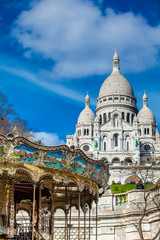 Fototapeta premium Carrousel and the Sacre Coeur Basilica at the Montmartre hill in Paris France