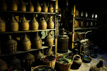 Interior of the old winery with wine bottles and grapes, Meteora monastery, Thessaly, Greece