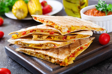 Mexican Quesadilla wrap with chicken, corn and sweet pepper and tomato sauce