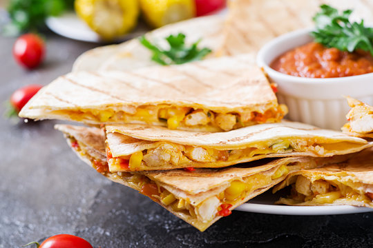 Mexican Quesadilla wrap with chicken, corn and sweet pepper and tomato sauce