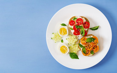Breakfast. Sandwich with cream cheese with tomatoes and cream cheese. Top view. Flat lay