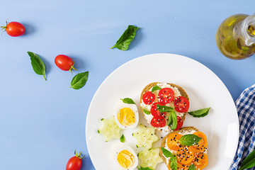 Breakfast. Sandwich with cream cheese with tomatoes and cream cheese. Top view. Flat lay
