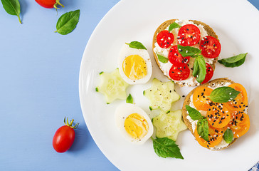 Breakfast. Sandwich with cream cheese with tomatoes and cream cheese. Top view. Flat lay