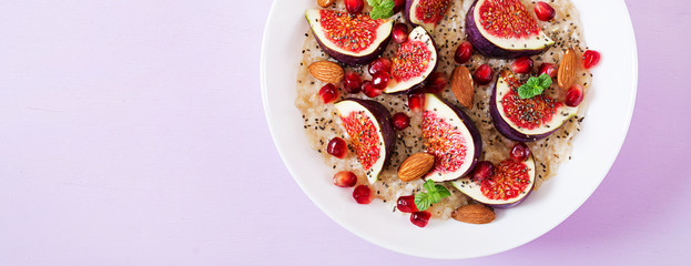 Delicious and healthy oatmeal with figs, almond and chia seeds. Healthy breakfast. Fitness food. Proper nutrition. Flat lay. Top view. Banner