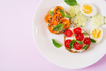 Breakfast. Sandwich with cream cheese with tomatoes and cream cheese. Top view. Flat lay