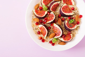 Delicious and healthy oatmeal with figs, almond and chia seeds. Healthy breakfast. Fitness food. Proper nutrition. Flat lay. Top view.