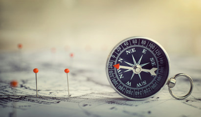 Magnetic compass on world map.Travel, geography, navigation, tourism and exploration concept background. Macro photo. Very shallow focus.