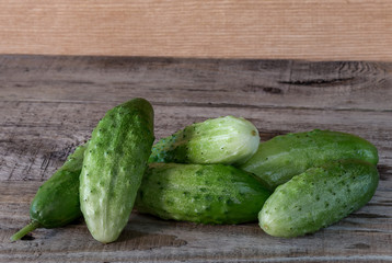 Fresh cucumbers on a wooden background