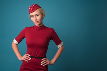 stewardess in red uniform on the sky background