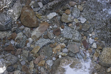 Through clear water you can see the stones. river spring water. colored stones. Crystal clear water in the waterfall.
