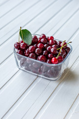 Red currants and berries, on a white table.