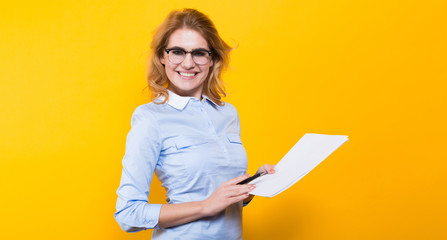 Blonde woman with blank paper and pen