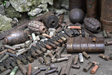 Military background with cartridges of grenades and machine-gun tape. Black archeology. World War II and its artifacts. Great Patriotic War of the USSR